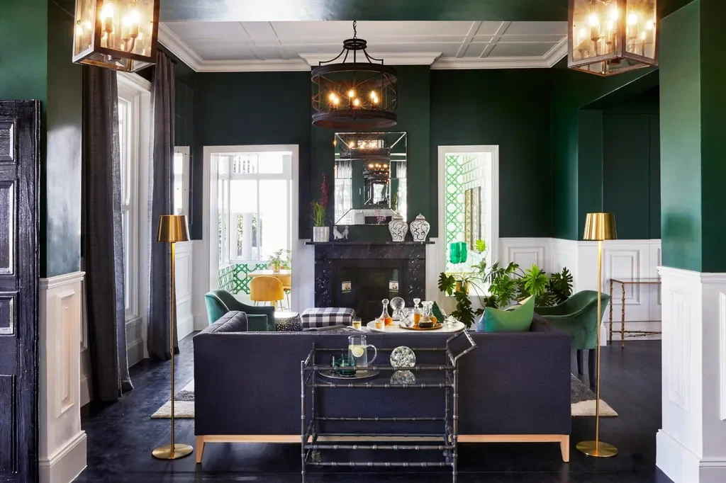 Cape Cadogan Boutique Hotel elegant lounge with fireplace, brass lighting and dark green walls, Cape Town