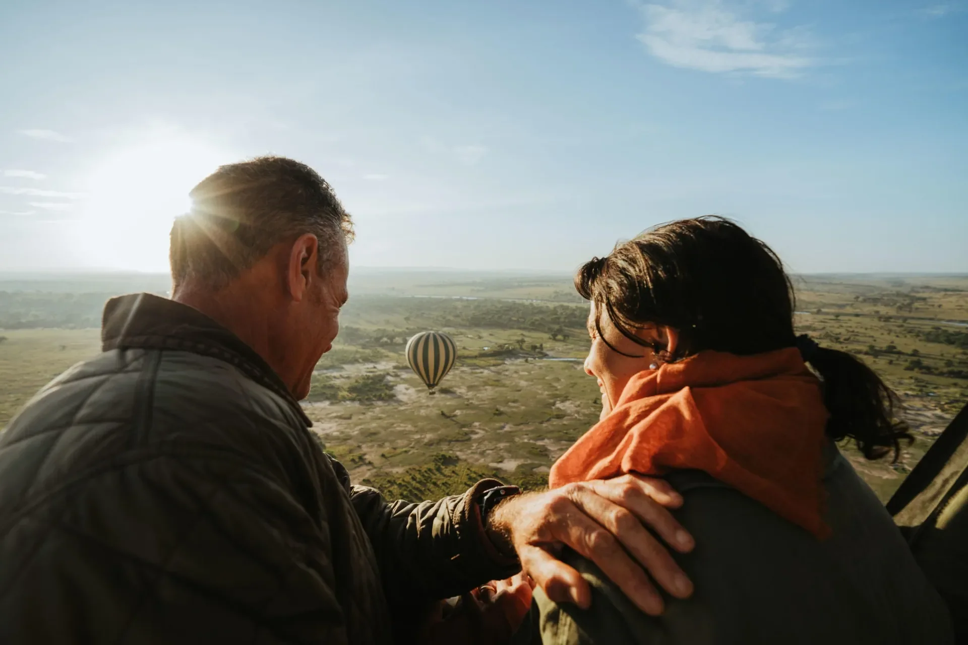Couple enjoying sunrise hot air balloon flight over the Serengeti with Usawa camp