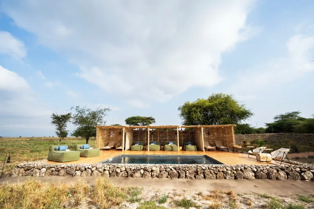 Swimming pool with shaded daybeds at Little Chem Chem, boutique safari camp near Lake Burunge