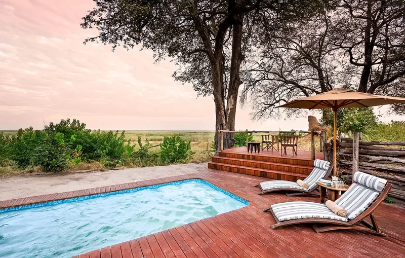 Plunge pool and sun loungers with views at Linyanti Bush Camp, Botswana, safari camp swimming pool