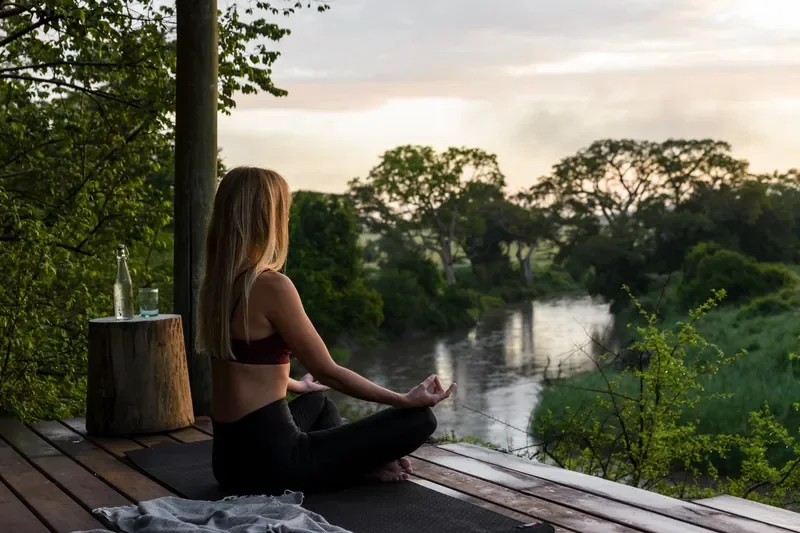 nomara-relaxation-wellness-singita-grumeti-yoga-deck-river-view-800w.webp