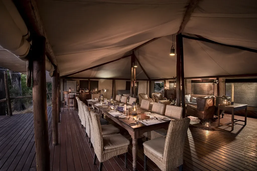 Communal dining in the mess tent at Linyanti Bush Camp, Botswana, alfresco style meals