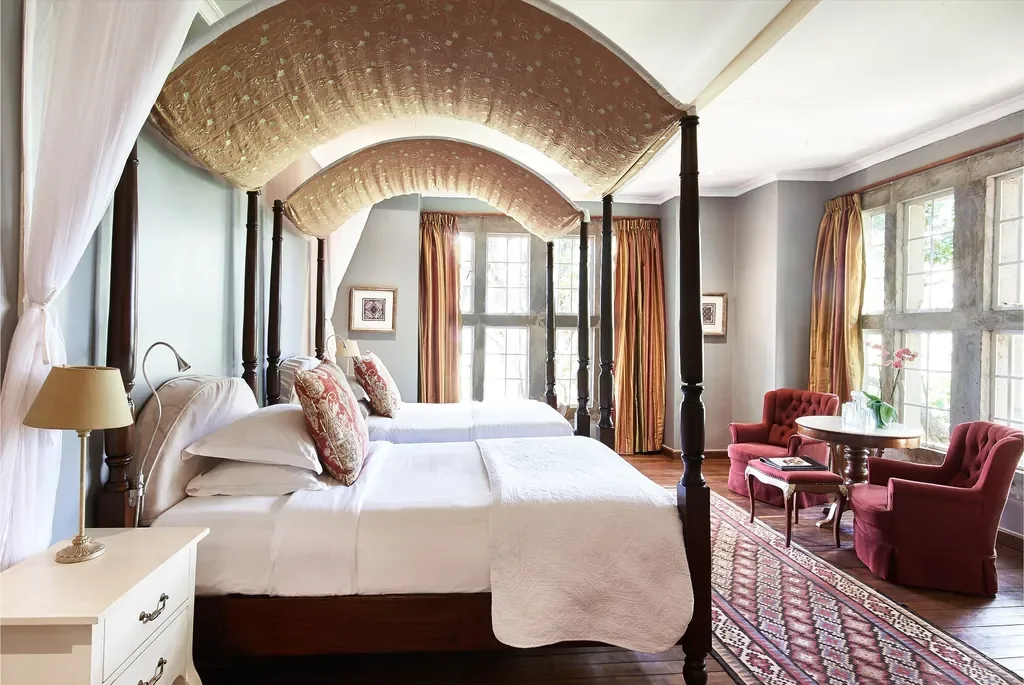Helen room twin four-poster beds at Giraffe Manor with heritage windows Nairobi Kenya