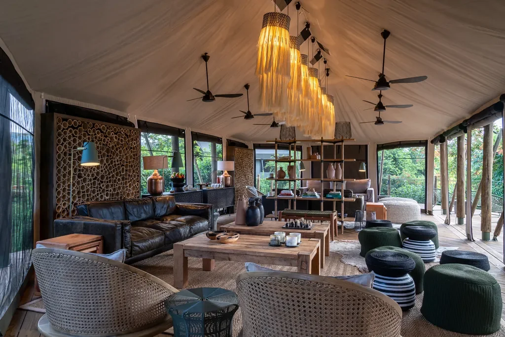 Magashi Camp lounge tent interior with chandeliers and rattan seating, Akagera National Park Rwanda