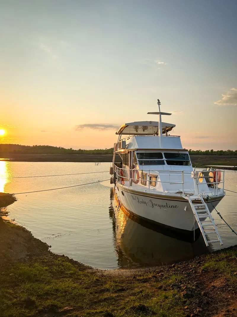 Lady Jacqueline houseboat anchored at sunset on a quiet Lake Kariba inlet, Zimbabwe