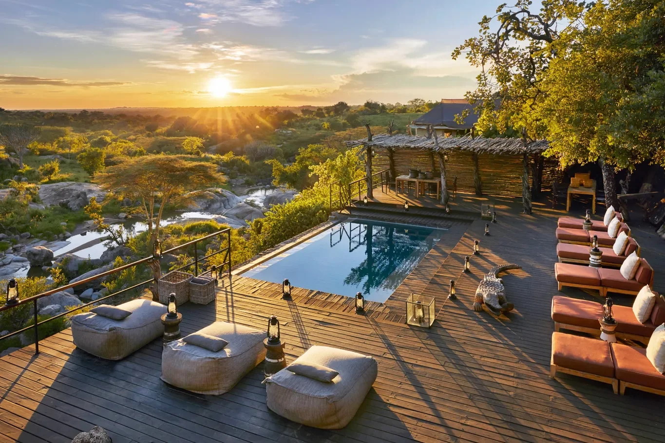 Sunset over Mwiba Lodge pool deck overlooking riverine woodland in Tanzania