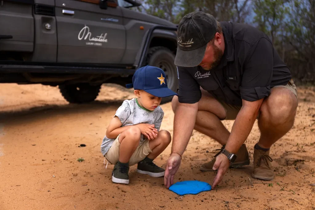 Guide teaching spoor casting to a child, Mack &amp; Madi family program at Marataba Safari Lodge, Marakele National Park
