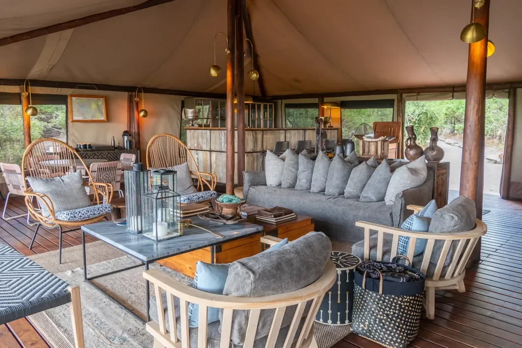 Open plan lounge in the main tent at Linyanti Bush Camp, Botswana, relaxed social space
