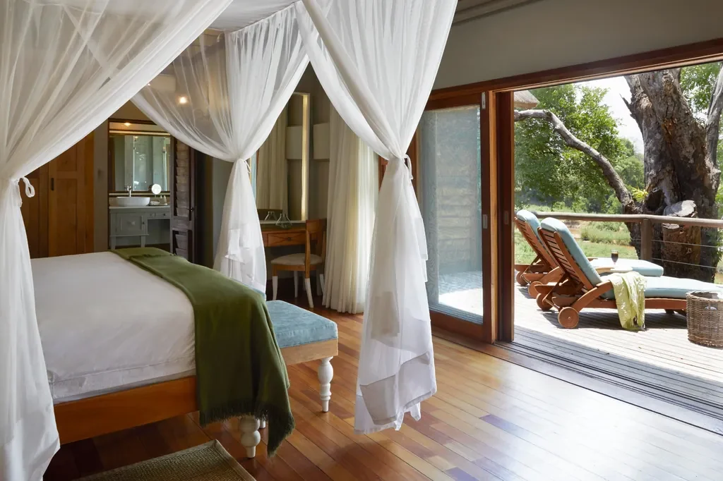 Narina Lodge suite with king-size canopy bed and private deck, Lion Sands, Greater Kruger, South Africa