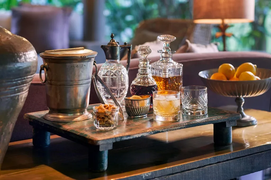 Outdoor lounge with crackling fireplace at Legendary Lodge Arusha, cozy evening setting