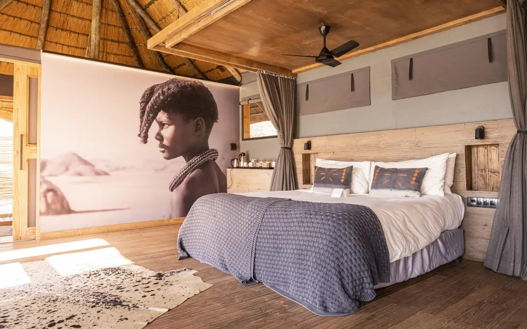 Serra Cafema bedroom with Himba-inspired mural and king-size bed, Kunene Namibia