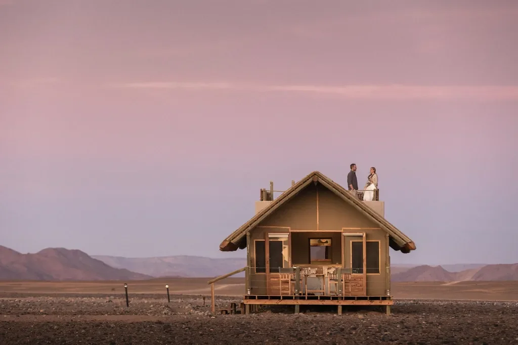 Kulala Desert Lodge standard room with rooftop stargazing deck at sunset