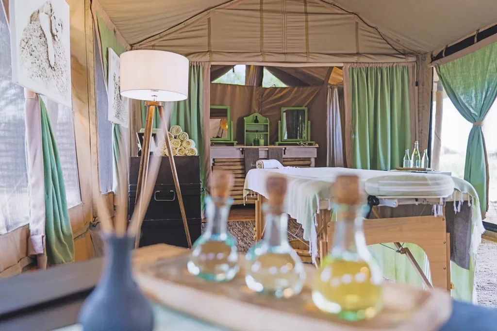 Wellness spa tent at Little Chem Chem with massage table and natural oils, Tanzania luxury camp