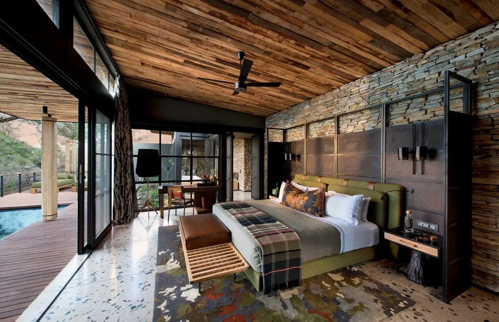 Elegant suite interior at Tengile River Lodge featuring stone walls and contemporary African design