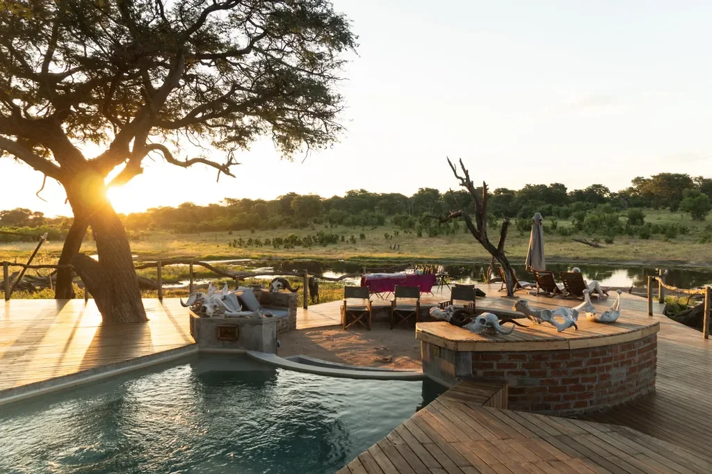 Somalisa Acacia pool deck and sundowner setup overlooking the pan, Hwange Zimbabwe