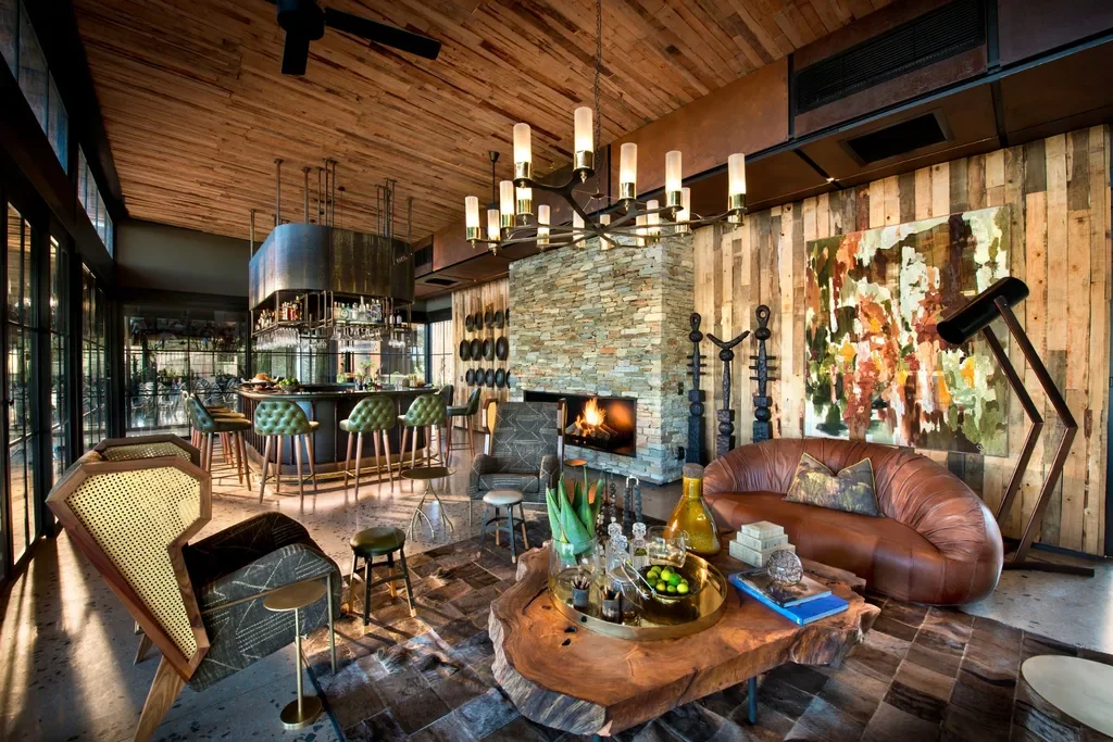 Designer indoor bar and lounge with fireplace at Tengile River Lodge