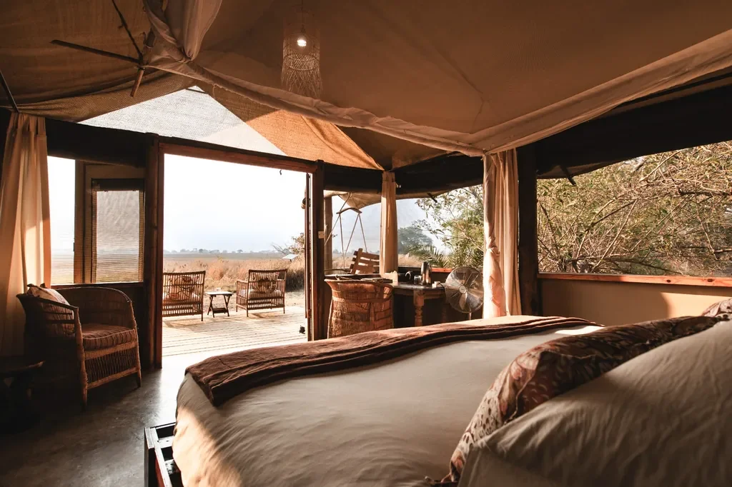 Tented suite interior with deck and floodplain views, Busanga Bush Camp Kafue National Park Zambia