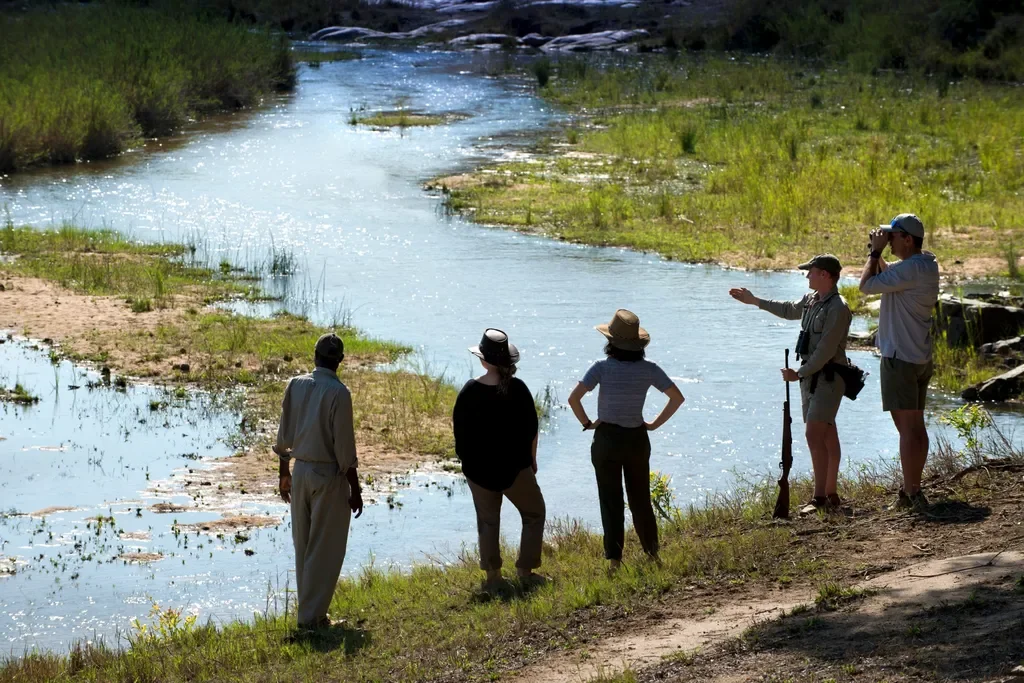 Guests on a guided walking safari along the Sand River at Tengile River Lodge, Sabi Sands, South Africa