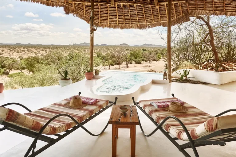 Loungers on private veranda with heart-shaped plunge pool and sweeping Samburu views at Sasaab, Kenya