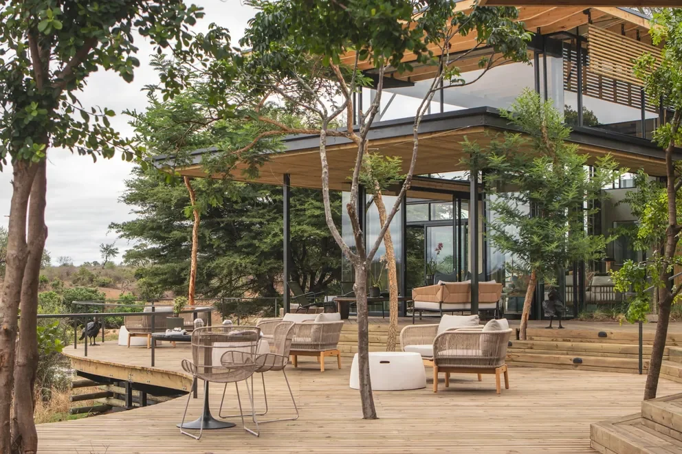 Riverside viewing deck at Lion Sands Ivory Lodge, Sabi Sand, Greater Kruger, South Africa with curved balustrade and café tables facing the Sabie River