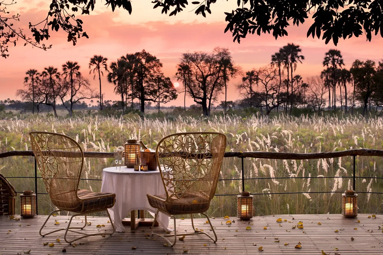 Romantic sunset drinks on the deck at Sandibe, Okavango Delta Botswana