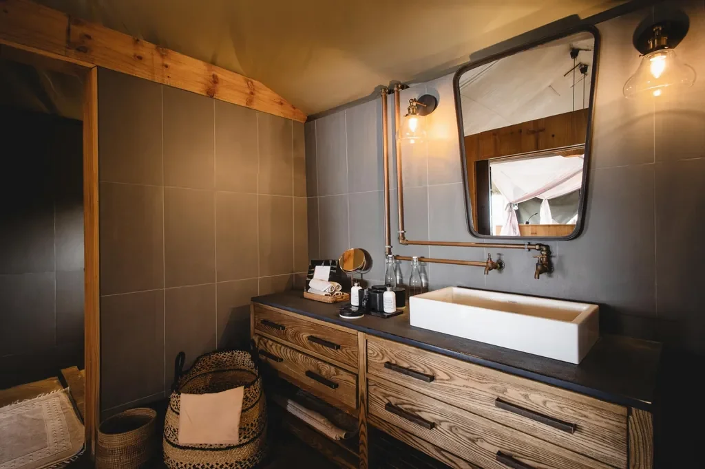 Magashi Camp bathroom with brass and timber finishes, Akagera National Park Rwanda
