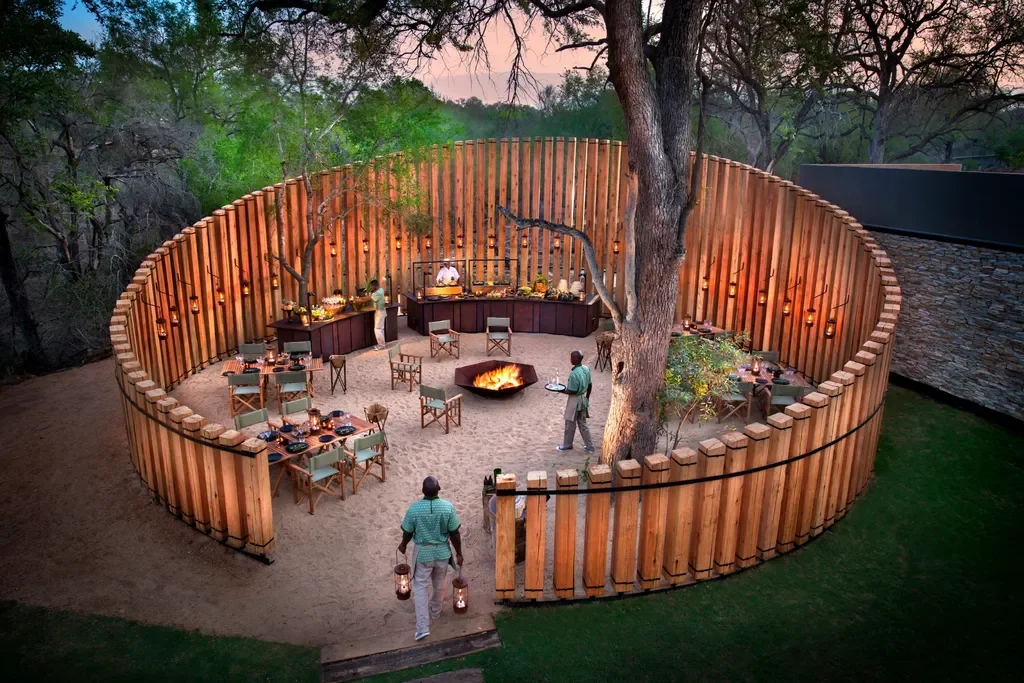 Circular boma dining under lanterns at andBeyond Tengile River Lodge