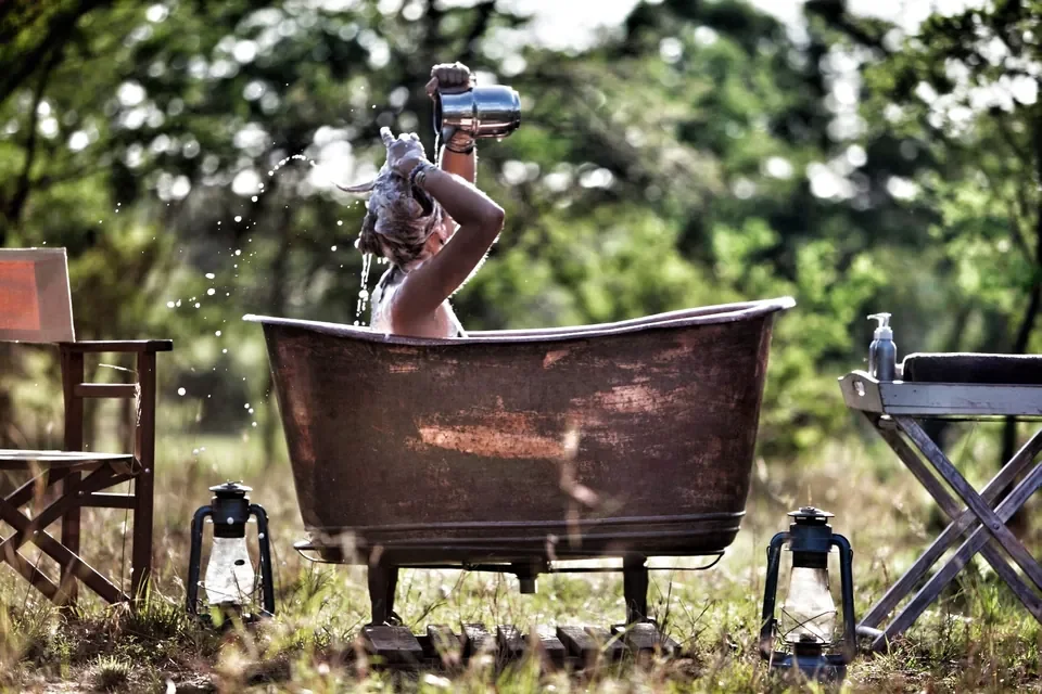 Outdoor copper bathtub experience at Serian's Serengeti South, Southern Serengeti, Tanzania