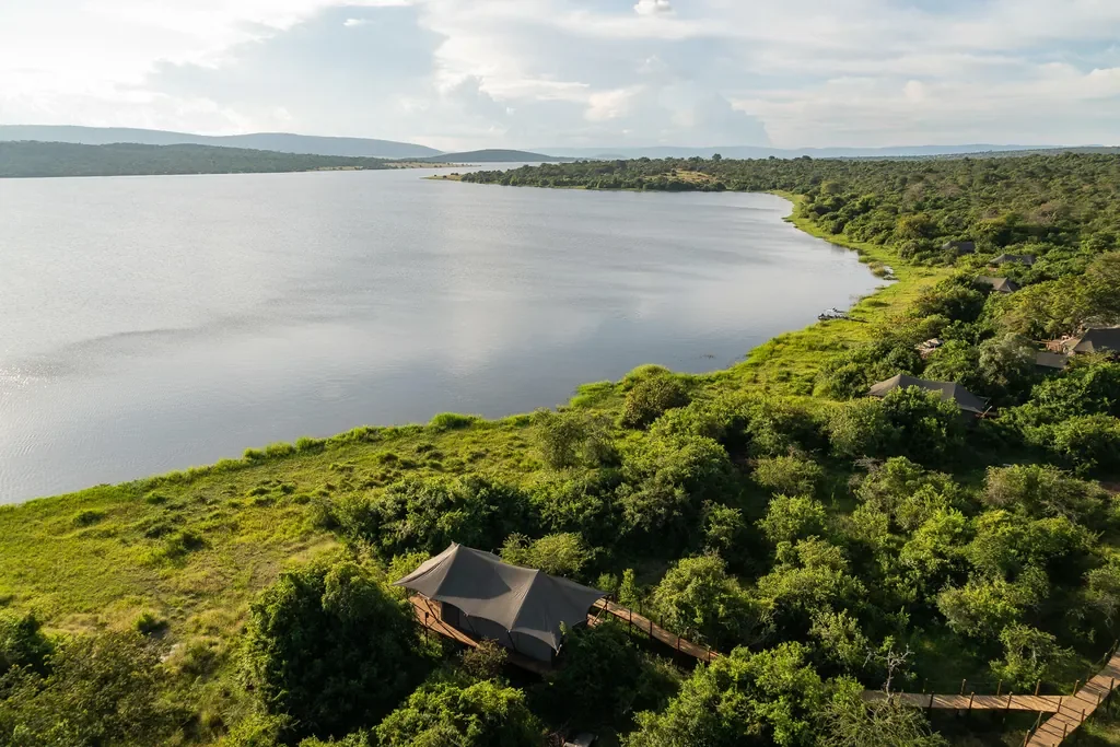 Aerial of Magashi Camp tents on Lake Rwanyakazinga shoreline, Akagera National Park Rwanda