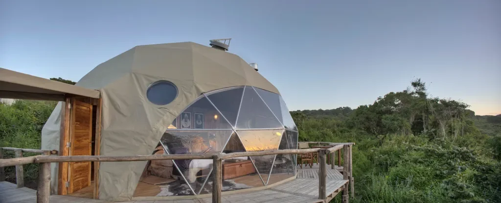 Exterior of geodesic dome suite with private deck and forest views at The Highlands, Ngorongoro