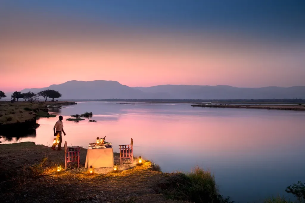 Private riverside dinner at sunset on the Zambezi, Zambezi Expeditions Camp, Mana Pools
