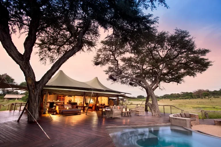 Somalisa Acacia main canvas lounge with pool deck at sunset in Hwange National Park