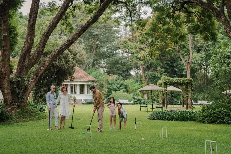 Family croquet on the lawn at Legendary Lodge Arusha, garden games at a Tanzania coffee estate