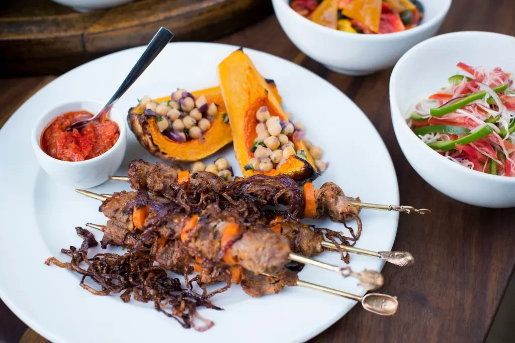 Lake Manyara Tree Lodge, Tanzania – plated Tanzanian cuisine with fresh salads and skewers