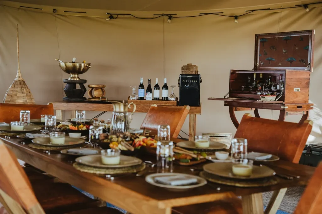Usawa camp dining table and field bar setup inside the stretch tent