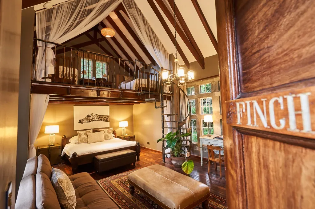 Family loft room at Giraffe Manor with spiral staircase and mezzanine, ideal Nairobi stopover hotel
