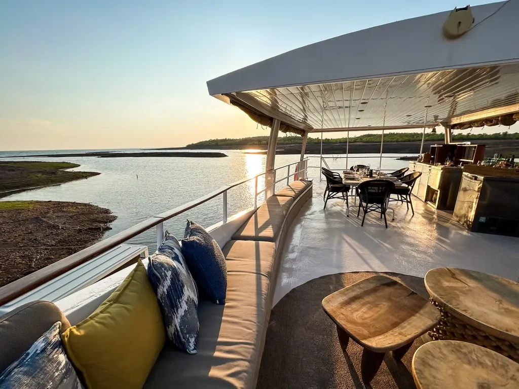 Upper deck lounge and dining area of the Lady Jacqueline houseboat at golden hour, Lake Kariba, Zimbabwe
