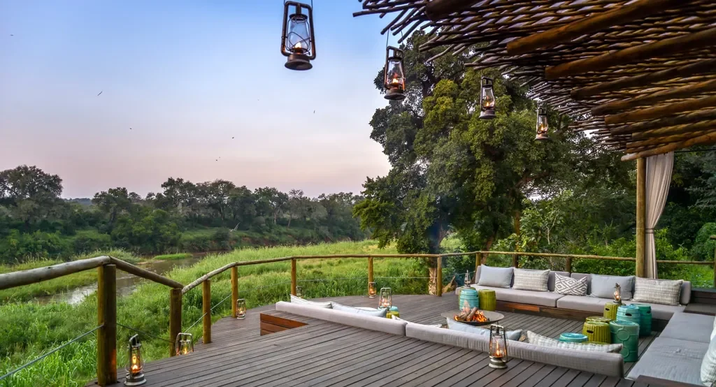Deck view with hanging lanterns across the Sabie River at Lion Sands Narina Lodge, Greater Kruger South Africa