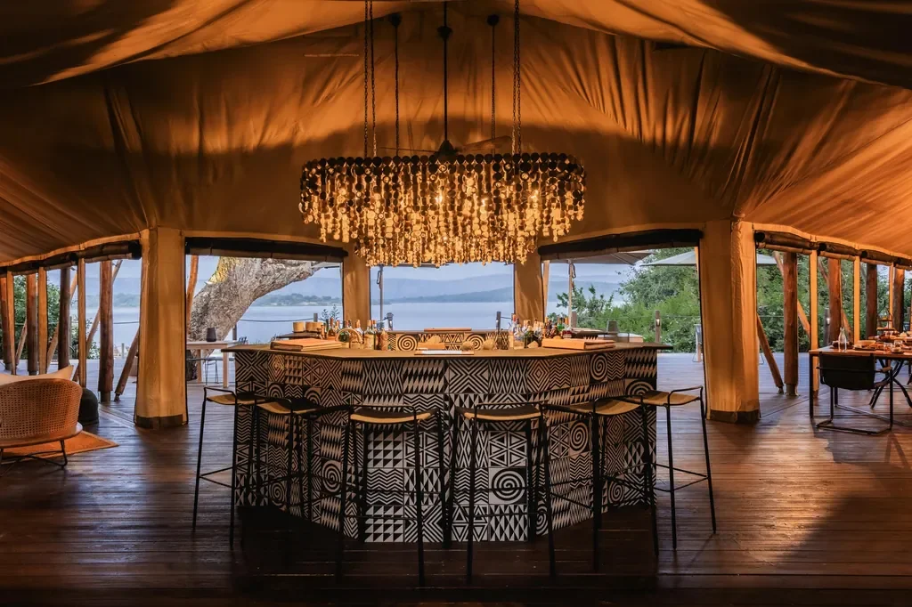 Magashi Camp bar with statement chandelier and lake views, Akagera Rwanda