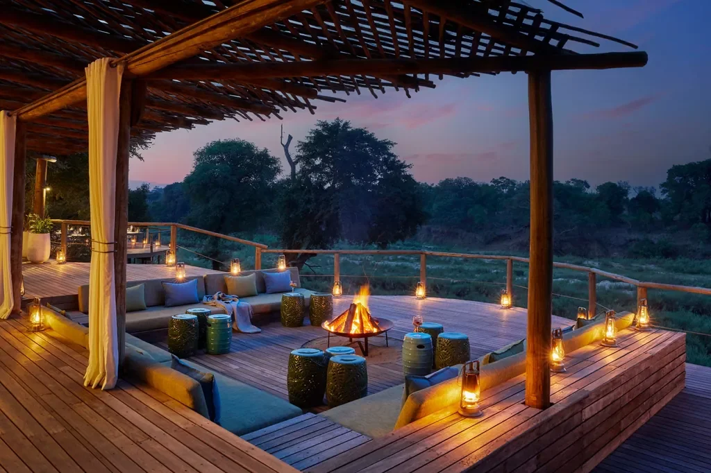 Sunken fire deck at sunset facing the Sabie River, Lion Sands Narina Lodge, Greater Kruger