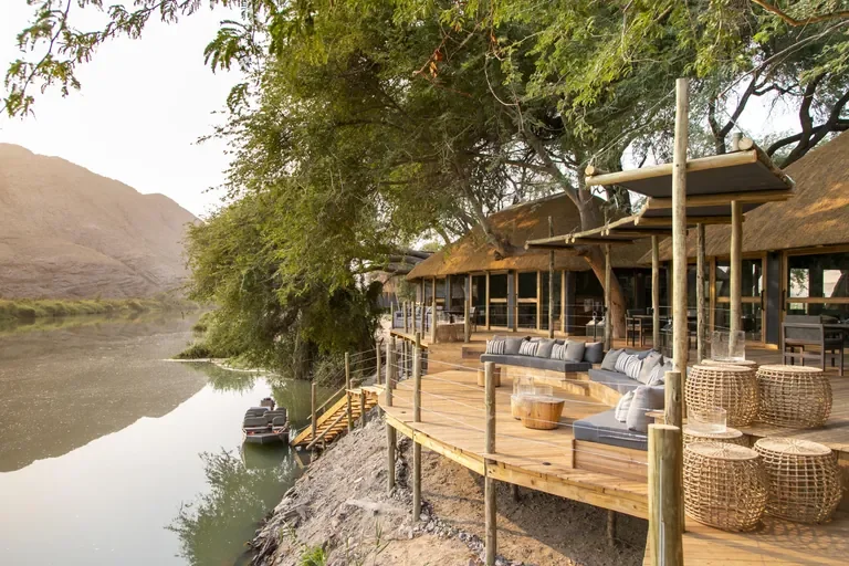 Serra Cafema riverside deck above the Kunene River with boat jetty, Hartmann Valley Namibia
