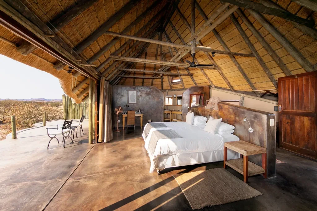 Spacious thatched suite at Wilderness Doro Nawas with open views across Damaraland, Namibia