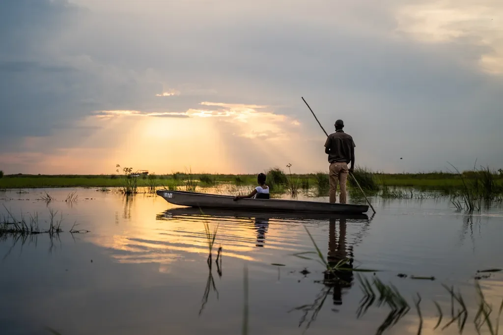 Mokoro canoe at sunset in the Linyanti wetlands, guided safari activity from Linyanti Bush Camp, Botswana