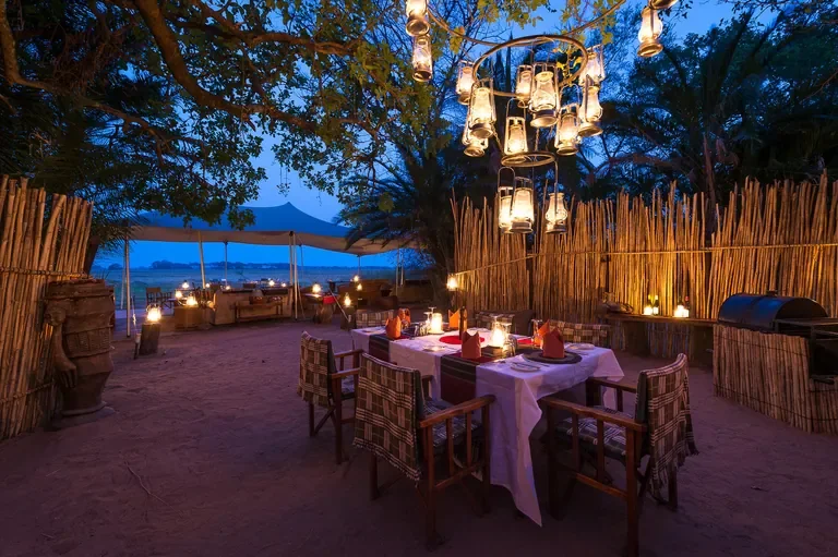 Lantern‑lit boma dining area at Busanga Bush Camp, Kafue National Park Zambia safari camp
