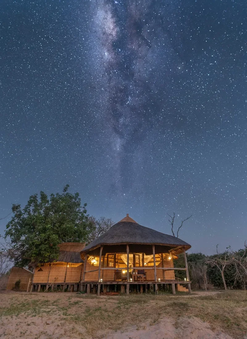 Milky Way stargazing above a thatched chalet at Nsolo Bush Camp, South Luangwa, Zambia