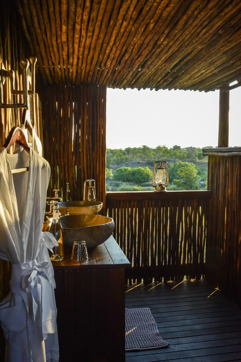 Outdoor bathroom with twin stone basins at Tinyeleti Treehouse, Lion Sands in the Sabi Sand, Greater Kruger.