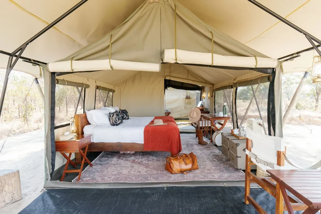 Spacious canvas safari tent bedroom at Time + Tide Luwi, South Luangwa