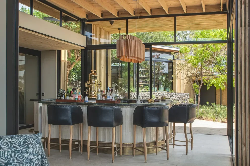 Contemporary bar and wine area at Lion Sands Ivory Lodge, Sabi Sand, Greater Kruger, South Africa, showcasing craft cocktails and South African wines