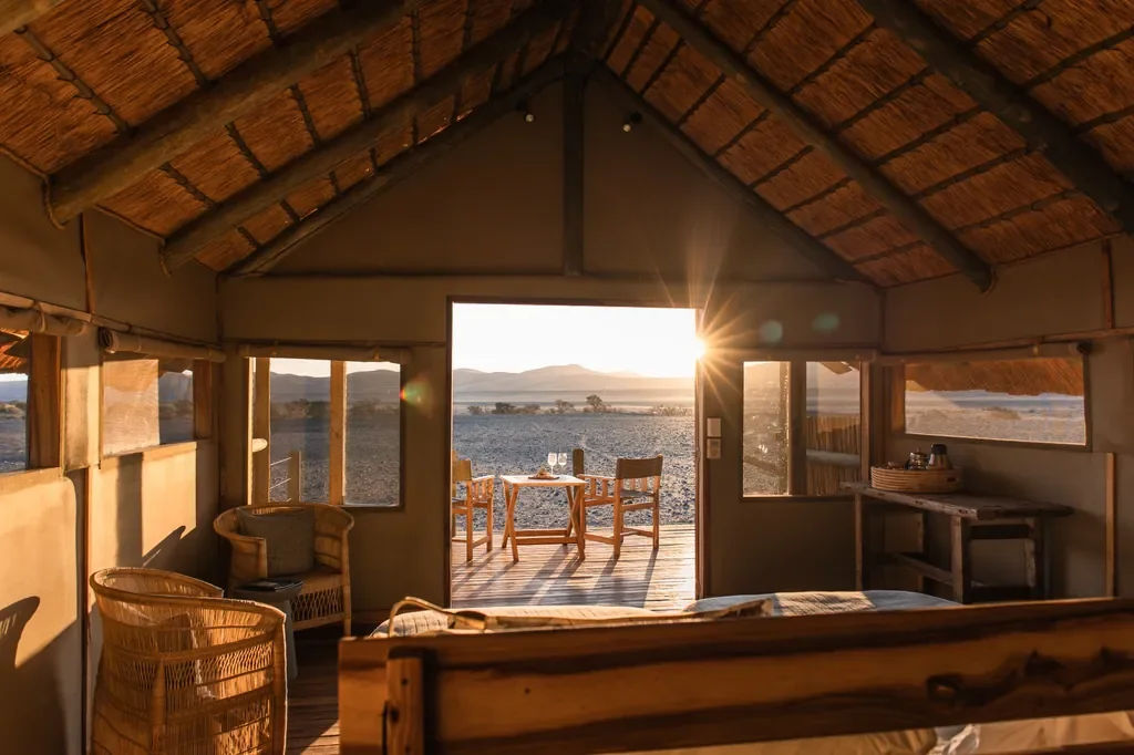 Kulala Desert Lodge standard tent interior sunrise with private deck