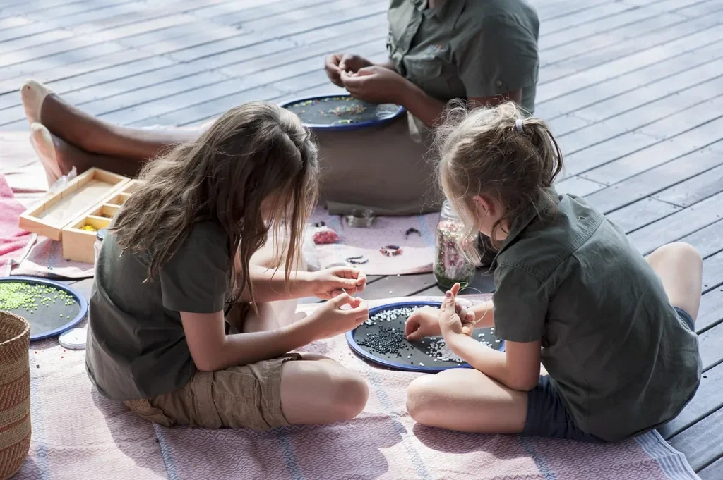 Kids beading and craft activity on the deck, Somalisa Acacia children’s programme Hwange